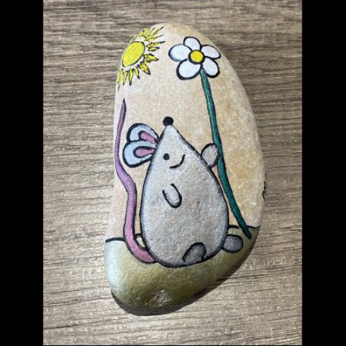 Marina Little mouse holding a daisy in the sun on rock