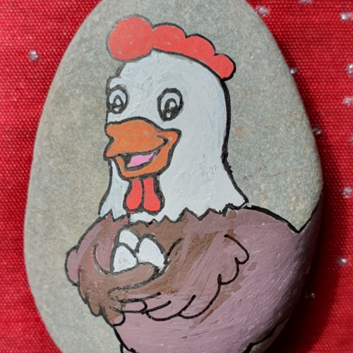 Happy chicken on rock