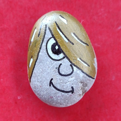 Teenage drawing on pebble